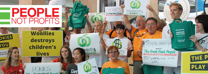 Crowd holding signs and chanting, caption reads People Not Profits